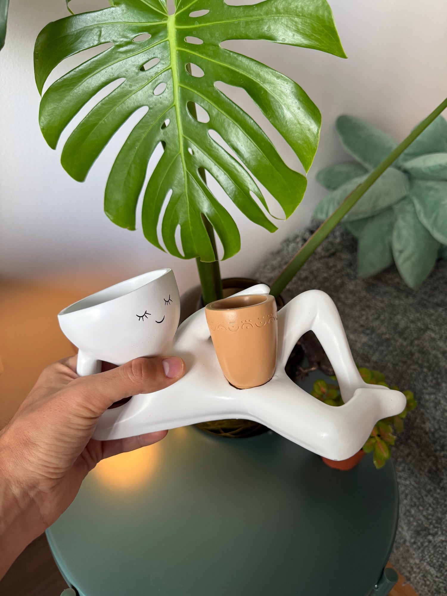 Lazy Guy planter held in hand to show its shape and planting openings